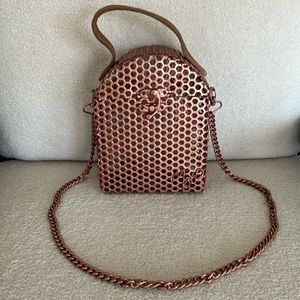 Unique rose gold wire bag with a leather top handle and strap. Made in Africa